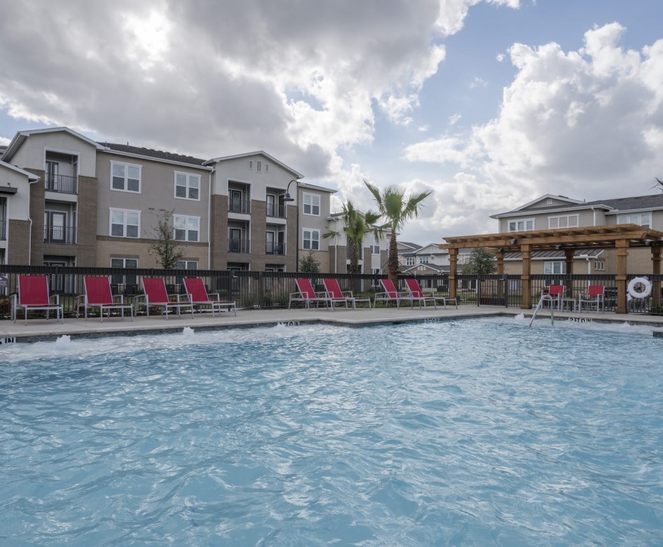 spacious pool area with reclining chairs and nearness to property