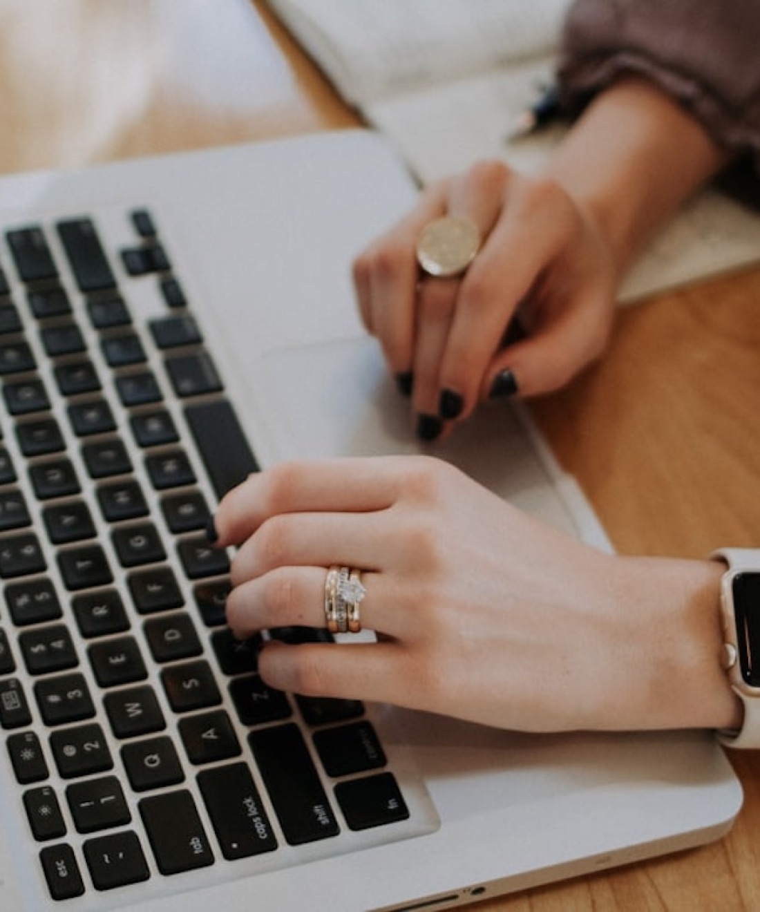 Our Team lifestyle image of a woman's hands typing on a laptop