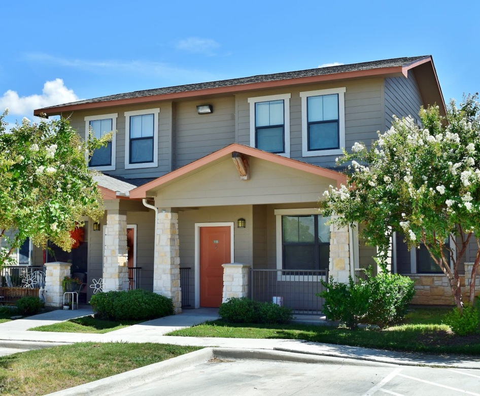 outside entrance to property showing some landscaping and spacious sidewalks