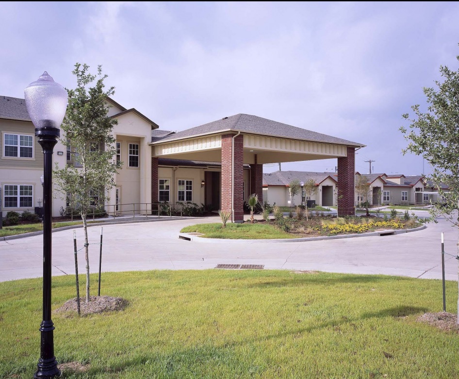 outside entrance to property showing some landscaping and spacious sidewalks