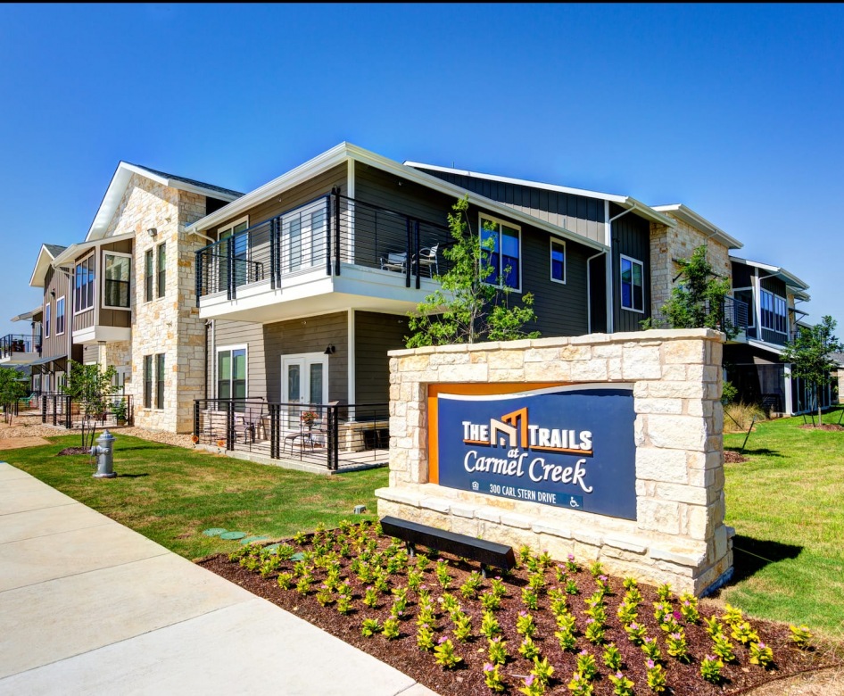 outside entrance to property showing some landscaping and spacious sidewalks