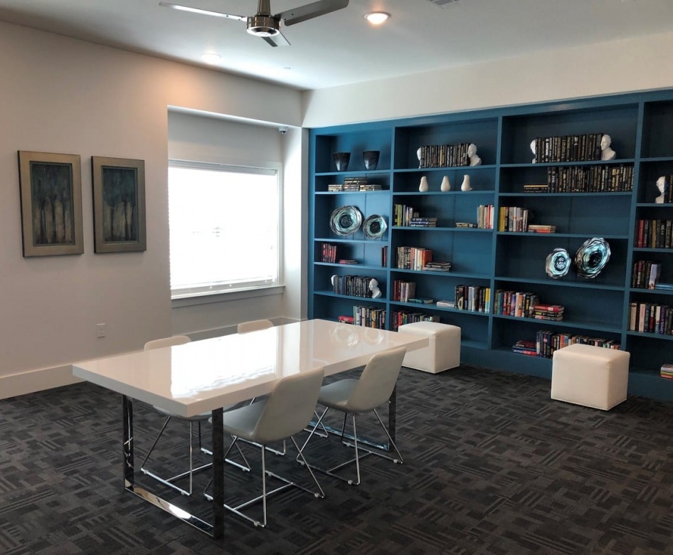 spacious library with seating and a wall of books