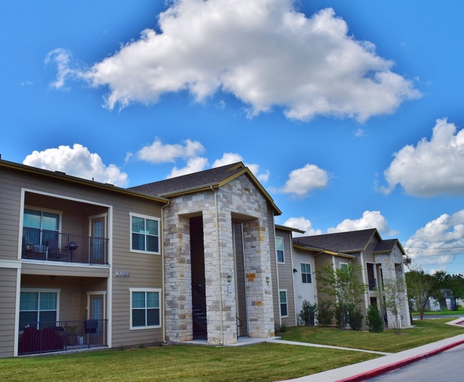 outside entrance to property showing some landscaping and spacious sidewalks