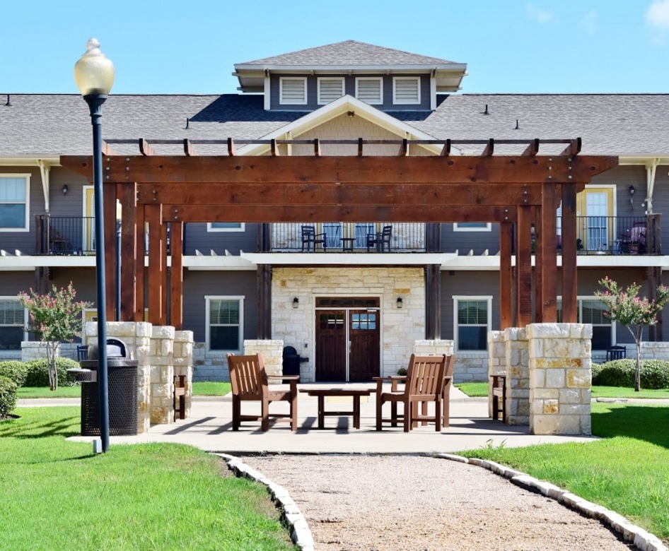 outside entrance to property showing some landscaping and spacious sidewalks